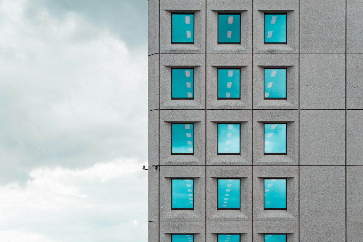 A grid of windows on a concrete office building facade