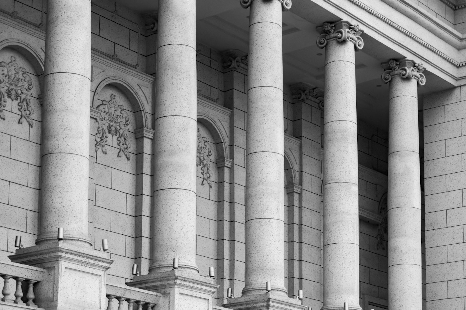 A row of classical stone columns on a building facade